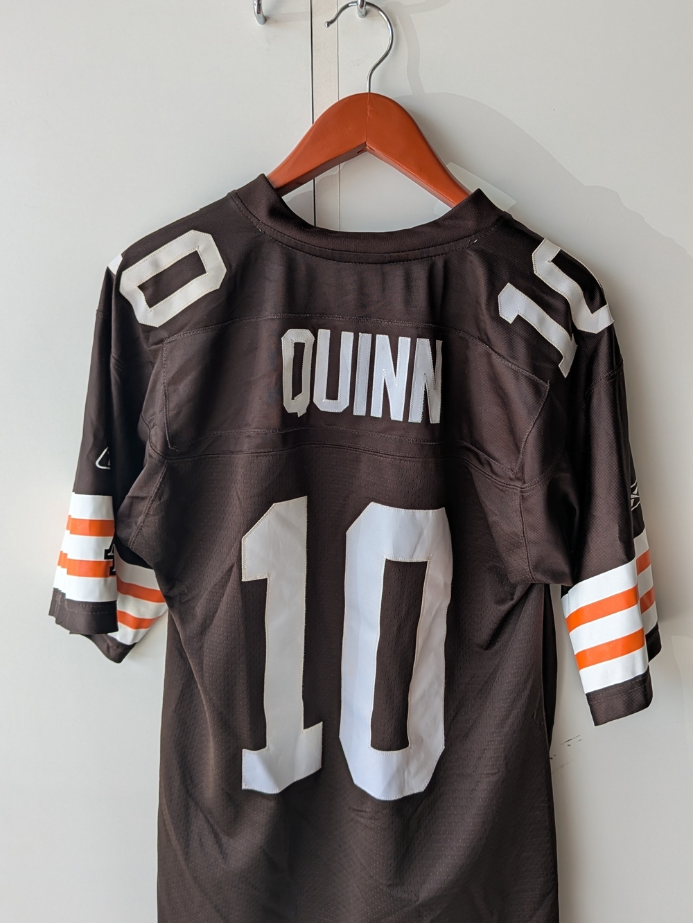 Reebok Quinn #10 Brown Football Jersey with White & Orange Stripes